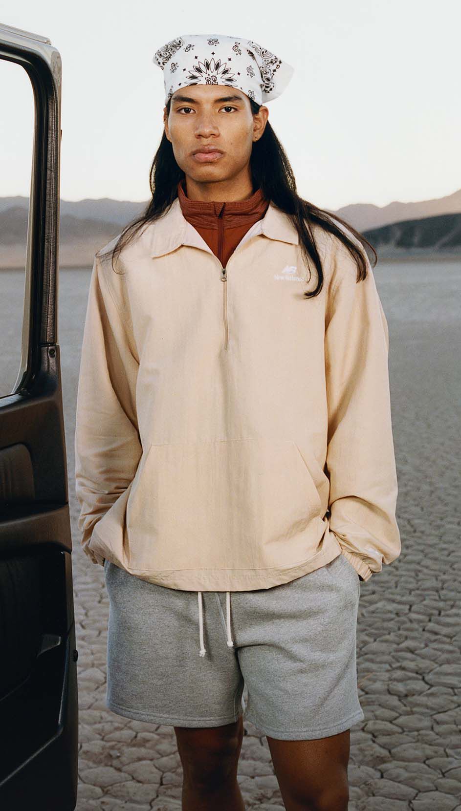 A man standing in a desert environment. 