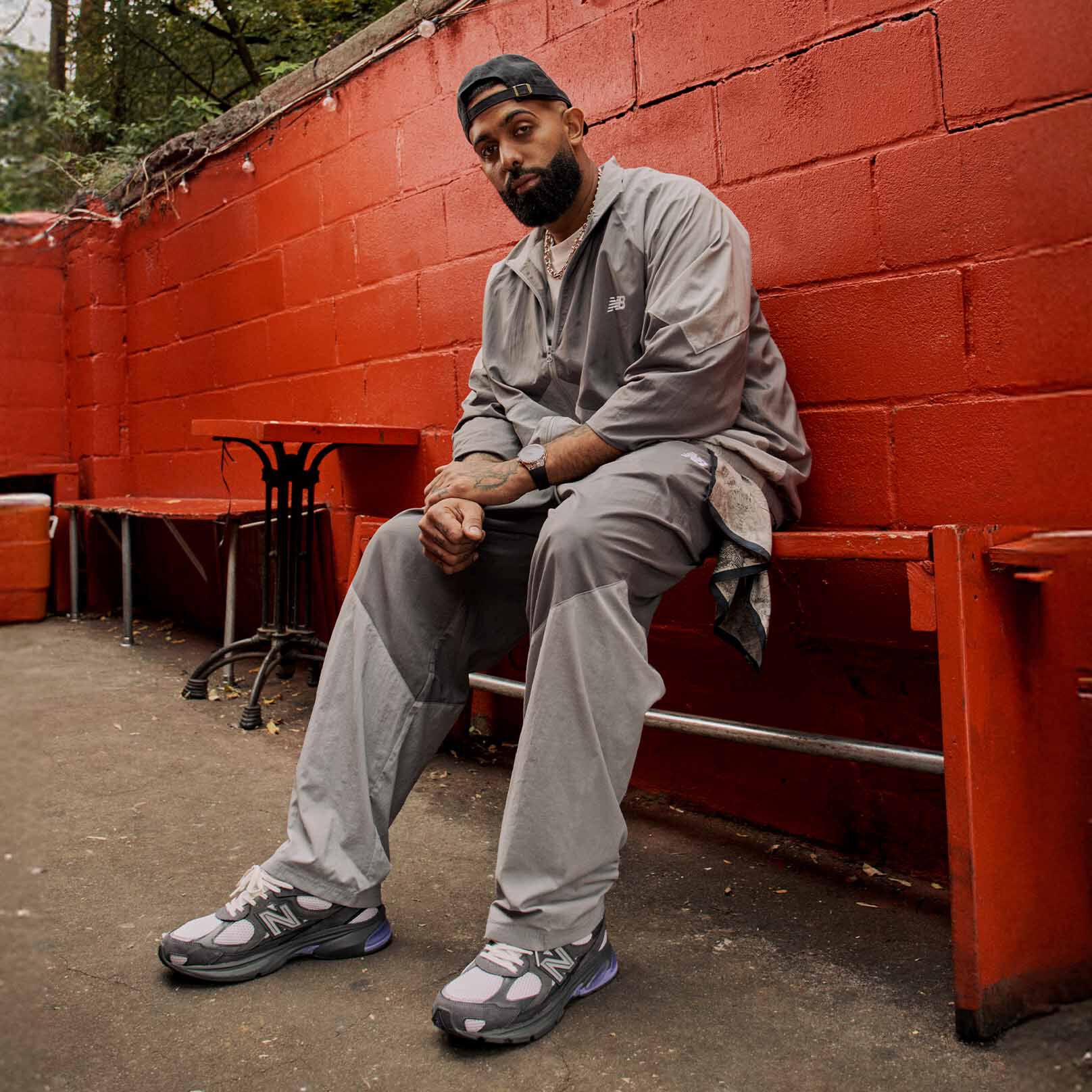 A head to toe shot of Eladio Carri&oacute;n sitting down while wearing the ABZORB 2010 shoe. 