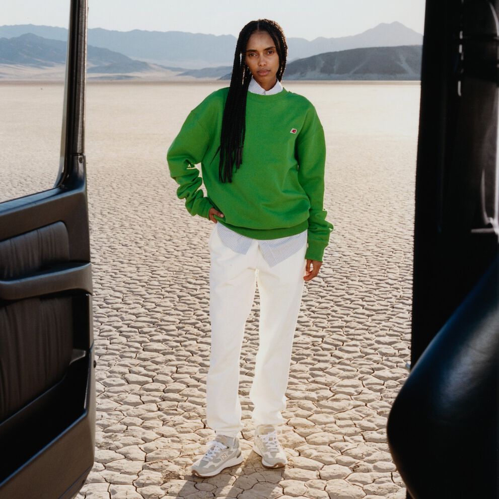 A woman standing in a desert environment.    
