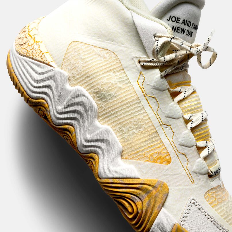 A close detail of the side of white and gold Kawhi II ‘Conversations Amongst Us’ showcasing the material and patterns.