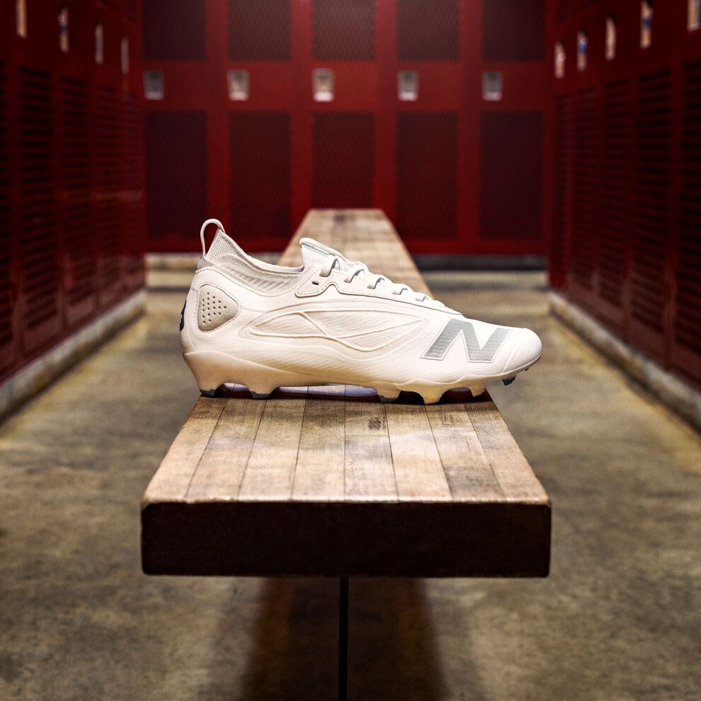 A white Rev X cleat in a locker room.