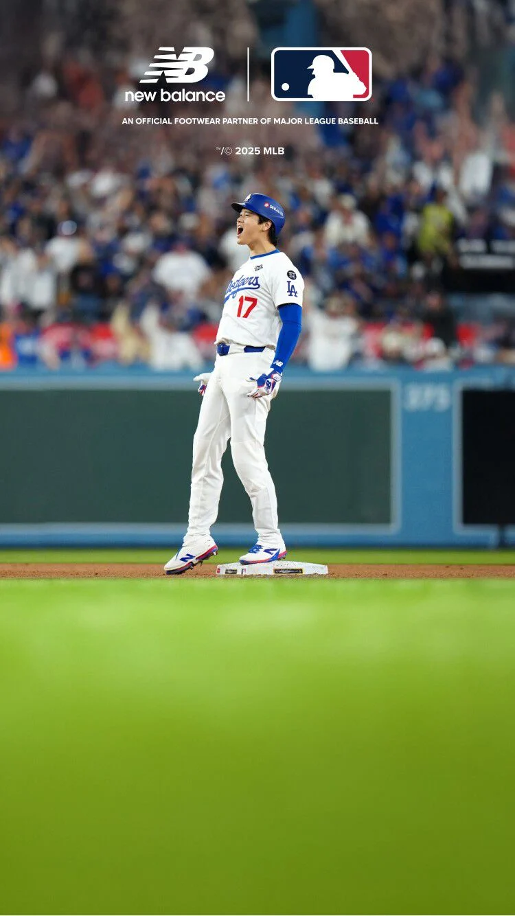 Ohtani celebrating on a baseball diamond in a Dodgers uniform. 