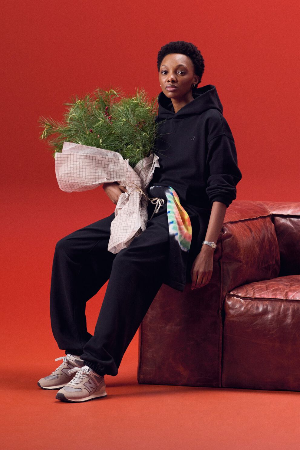 Young lady wearing a black outfit holding a bag of garland.