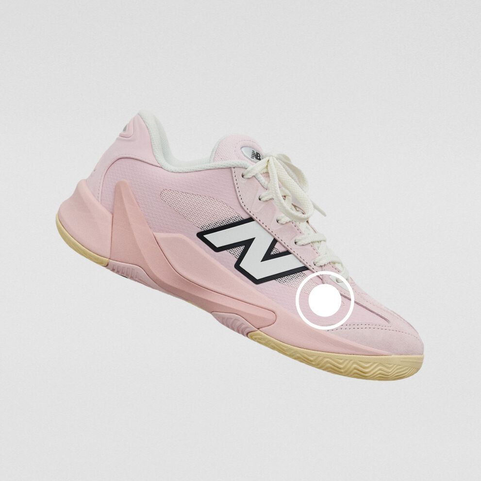 Light pink New Balance athletic sneaker with a mesh upper, oversized side logo, and gum rubber outsole.