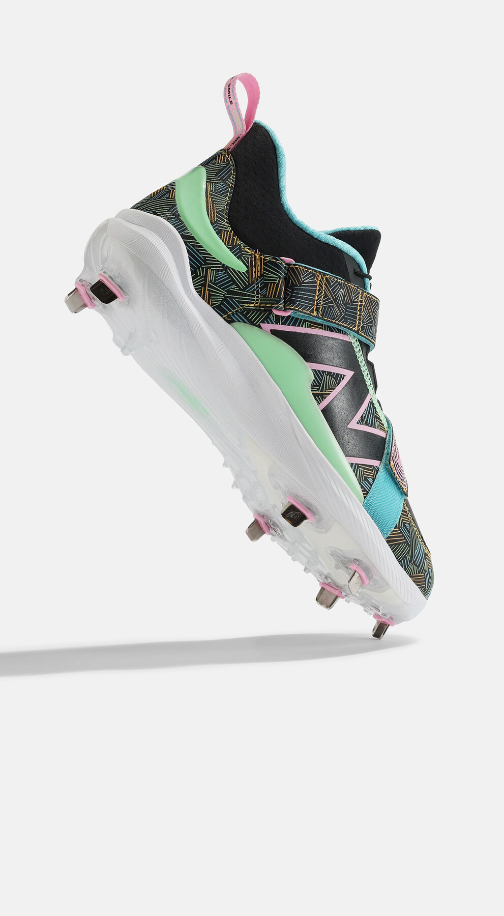 Single New Balance FuelCell Lindor 2 baseball cleat in multicolor tropical colors posed toe up against grey studio background 