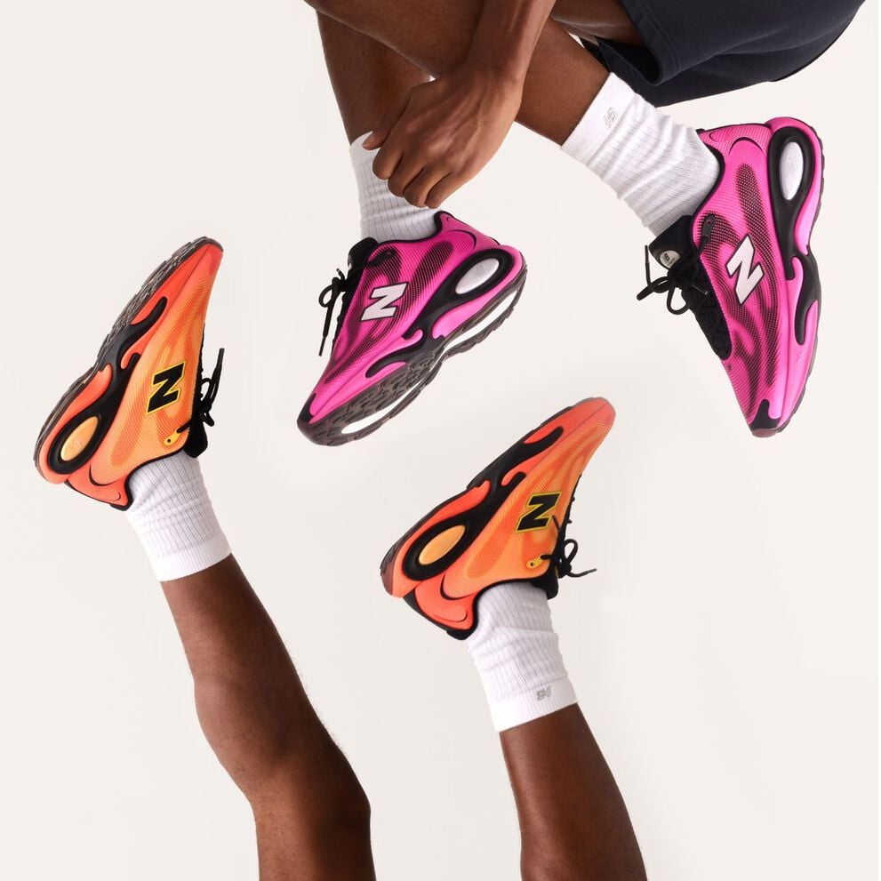 Two people wearing orange AC Runner shoes and pink AC Runner shoes on a white background.