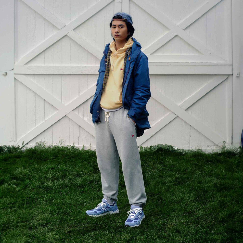 A man standing in front of set of white barn doors.