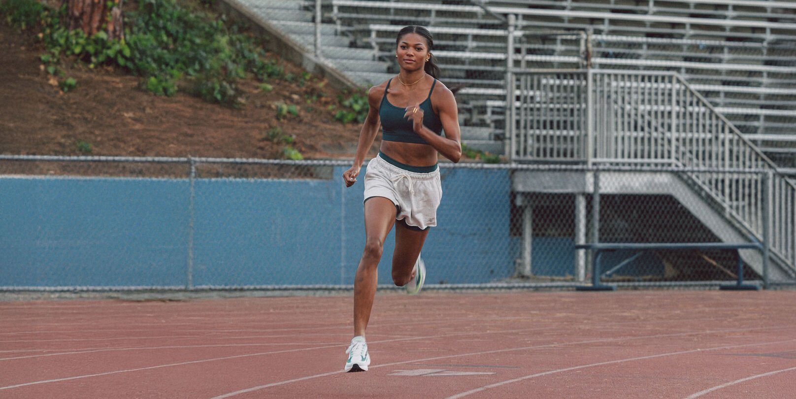 Gabby Thomas running on a track 