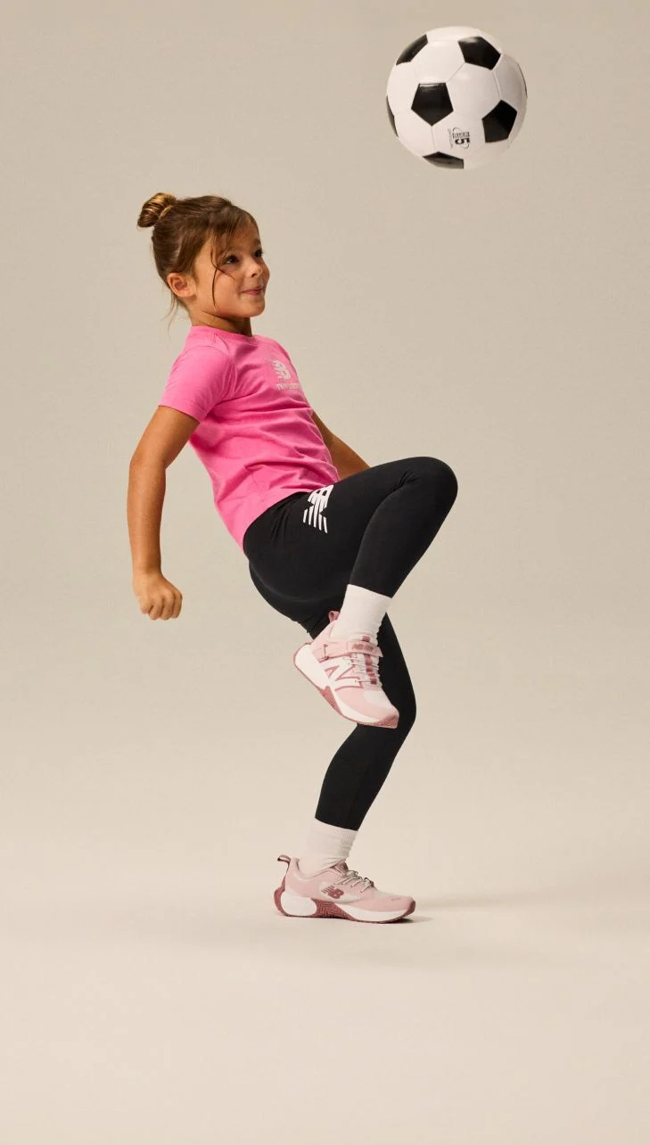 Girl wearing FuelCell Play shoes.