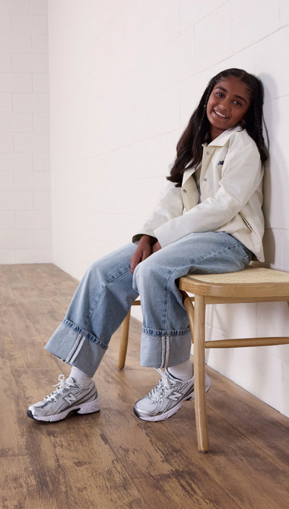 Girl sitting on wooden stool, wearing the 740