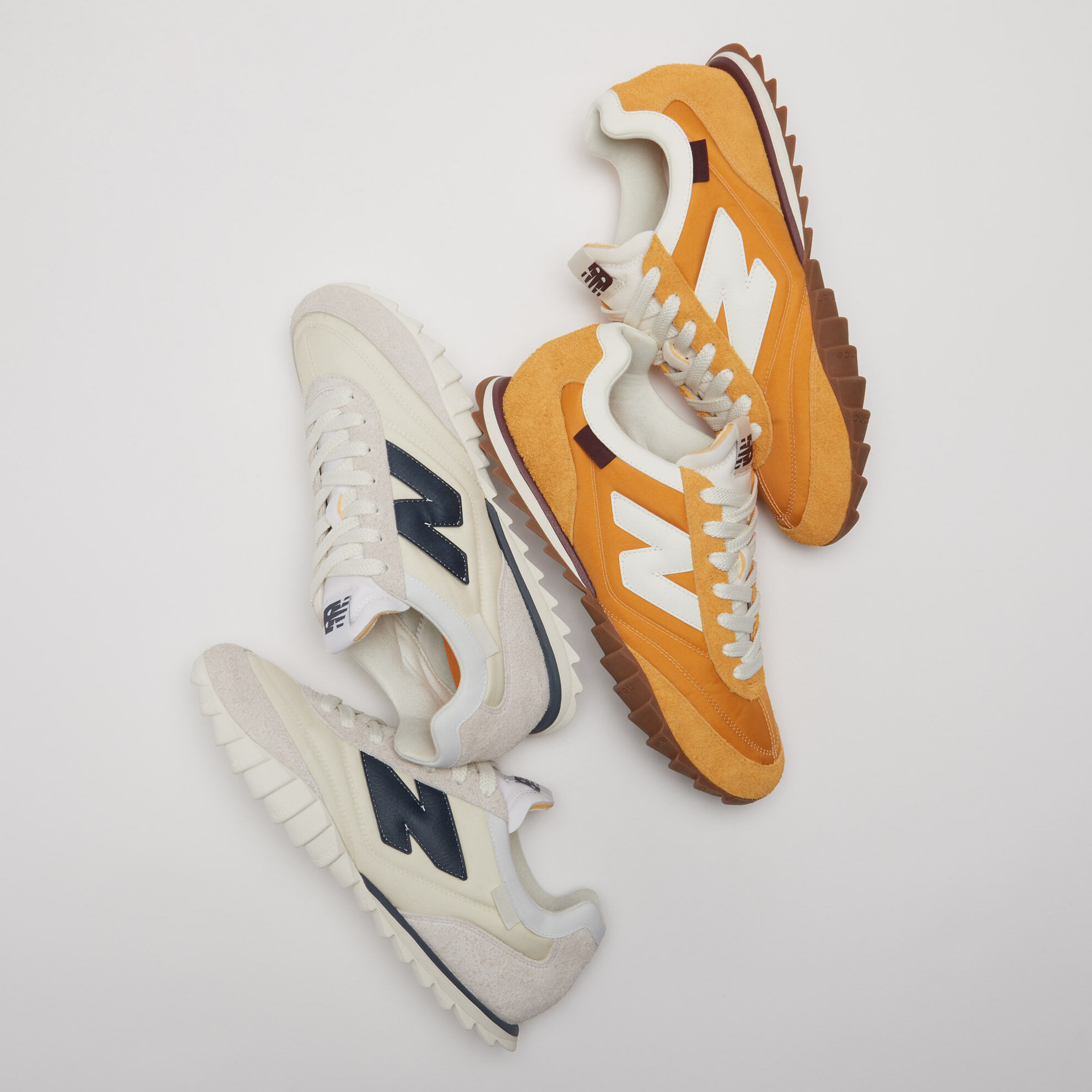 Grouping of both the orange and white pairs of the RC30 in a grey studio environment.