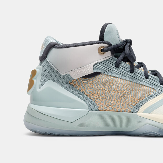 Close up view of the side of the light green basketball shoe.
