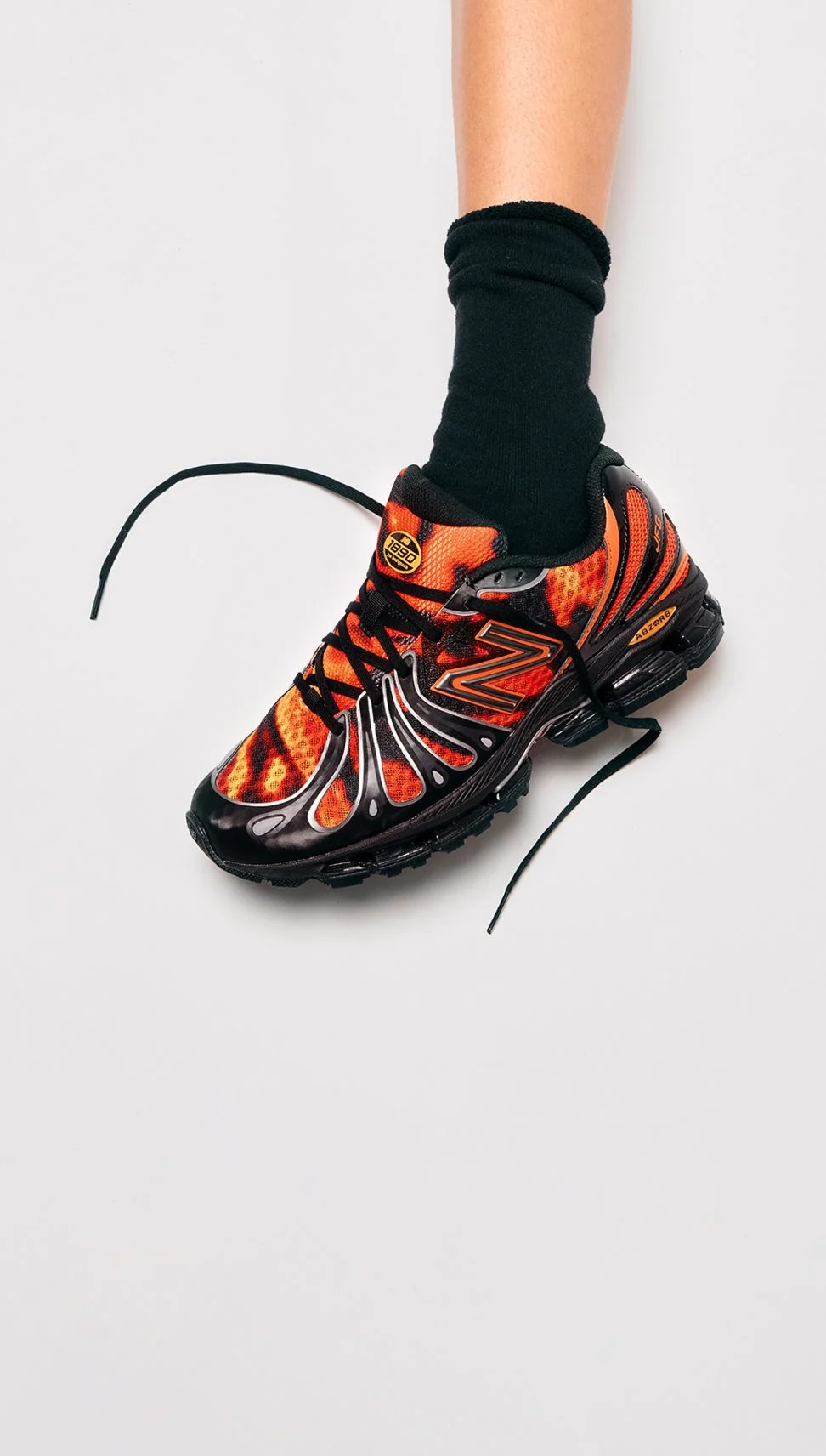 A knee-down image of a red sneaker on a person's foot.