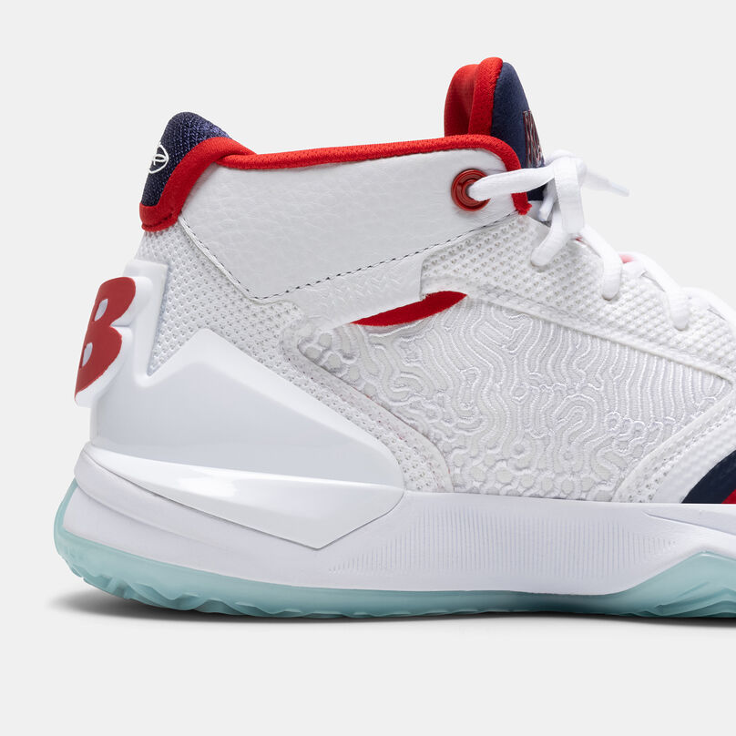 Cropped view of the heel of the white KAWHI basketball shoe with navy and red accents, on a grey background