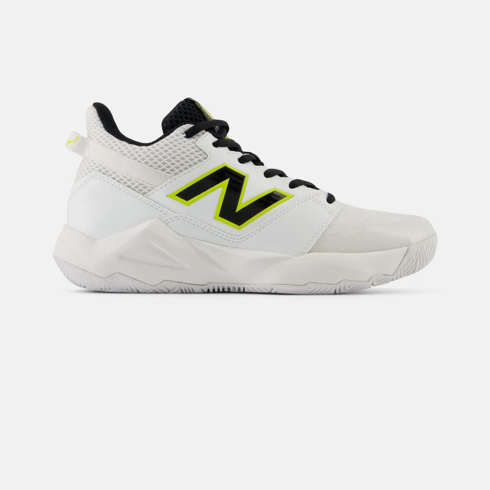 Side profile of a white New Balance tennis shoe on a white background, featuring a breathable mesh and synthetic upper, neon yellow‑outlined &ldquo;N&rdquo; logo, black laces, reinforced toe area, and a durable rubber outsole designed for court traction. 