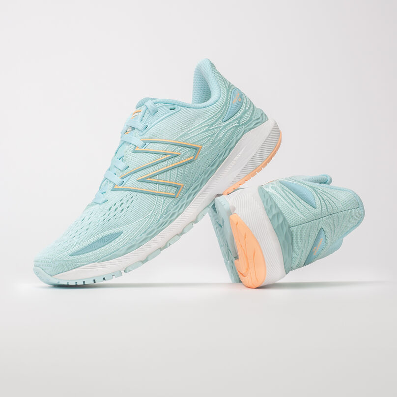 Left pair, side profile of light blue Fresh Foam X 860v12, resting on the heel of the right pair with heel facing front