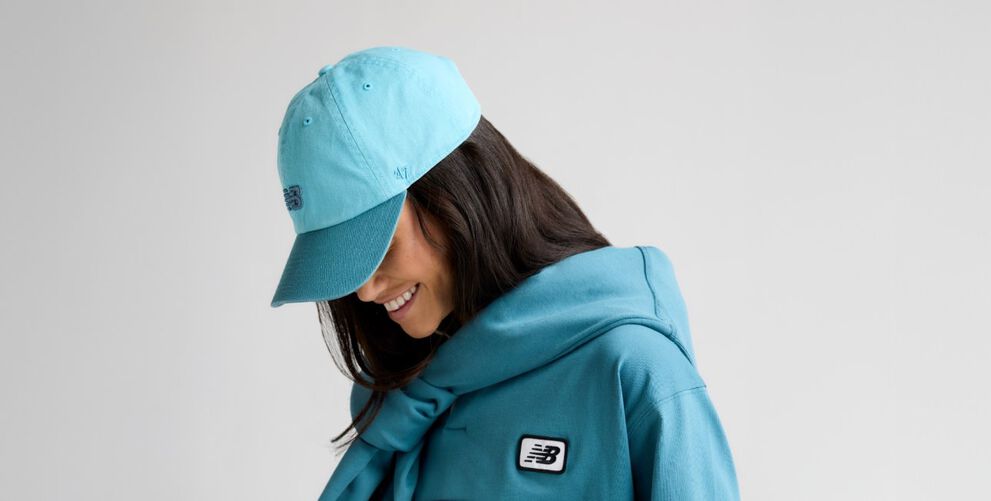 A close-up shot of a female looking to the side while wearing a &lsquo;47 hat. 