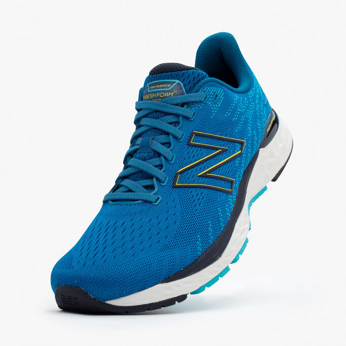 The blue shoe lifted up in the back with the toe on a grey background.