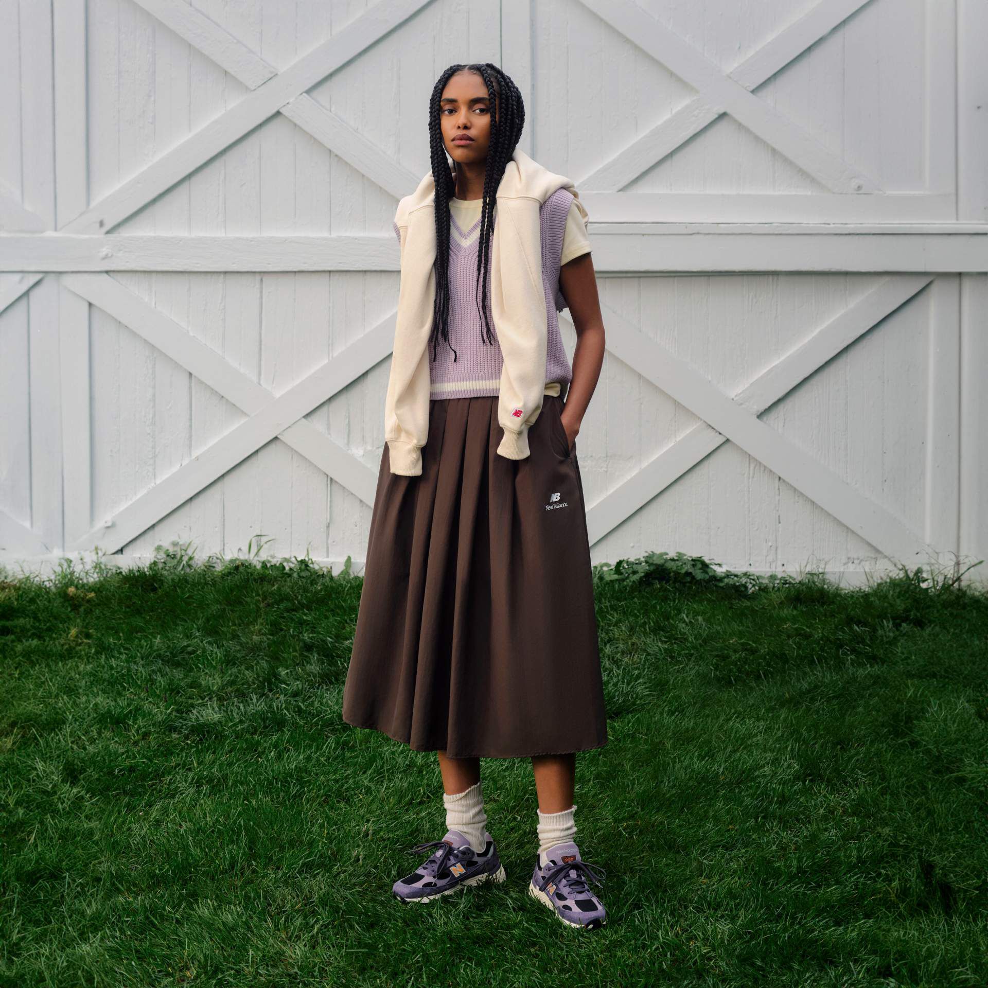 A person standing in front of a set of white barn doors.