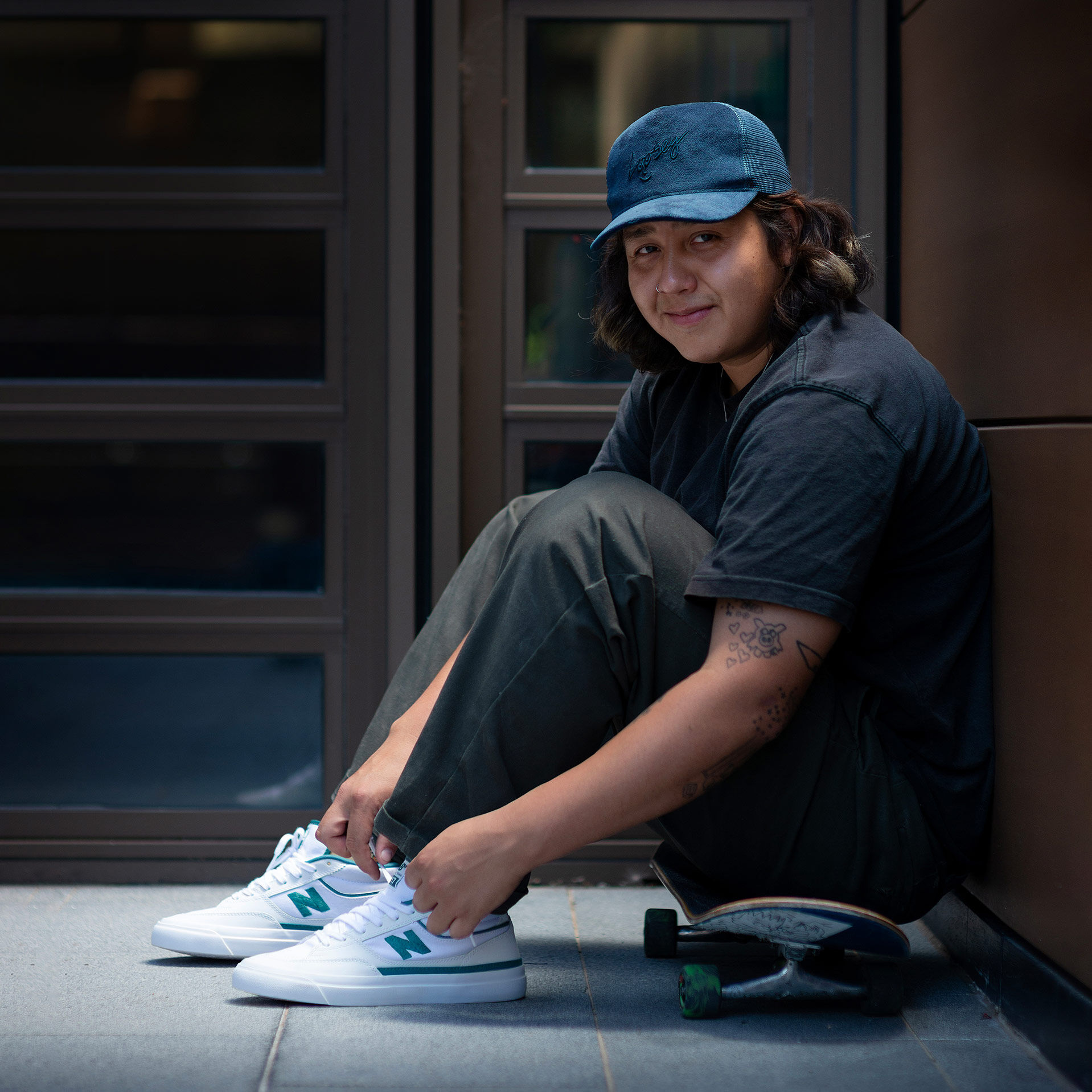 Franky Villani sitting on a skateboard wearing white Franky Villani 417 shoes.
