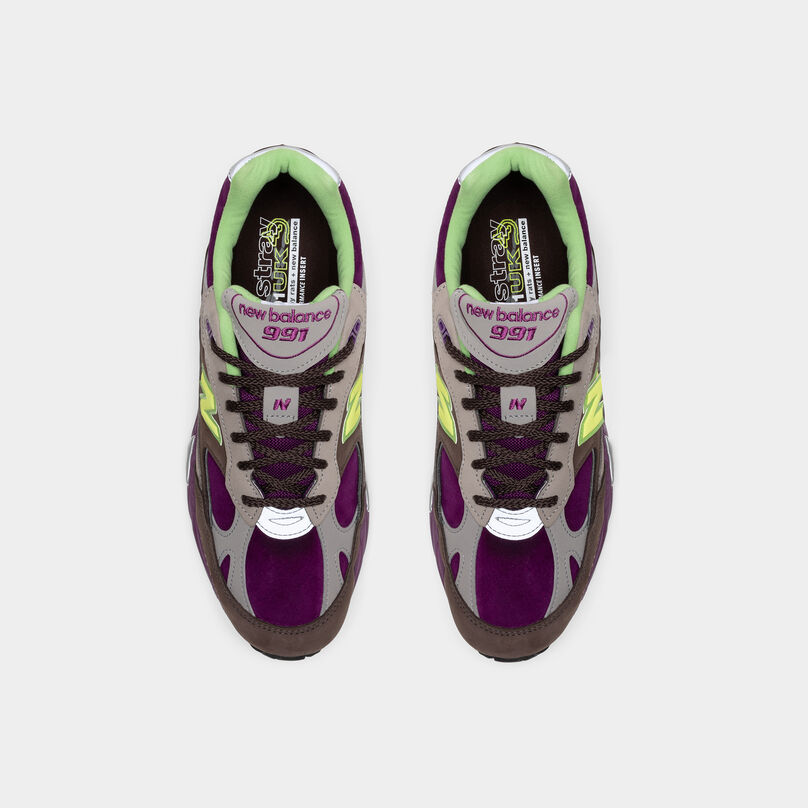 Pair of shoes sitting on a grey background from a birds eye view.
