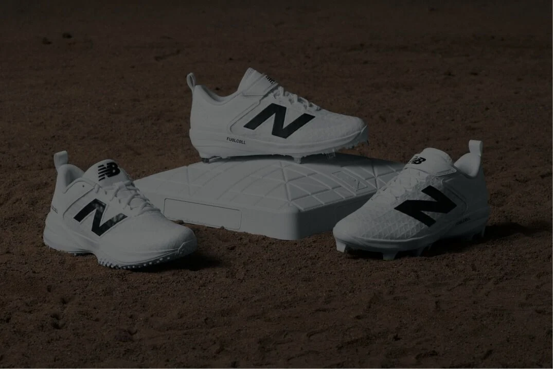 Cleats sitting on a baseball plate and dirt