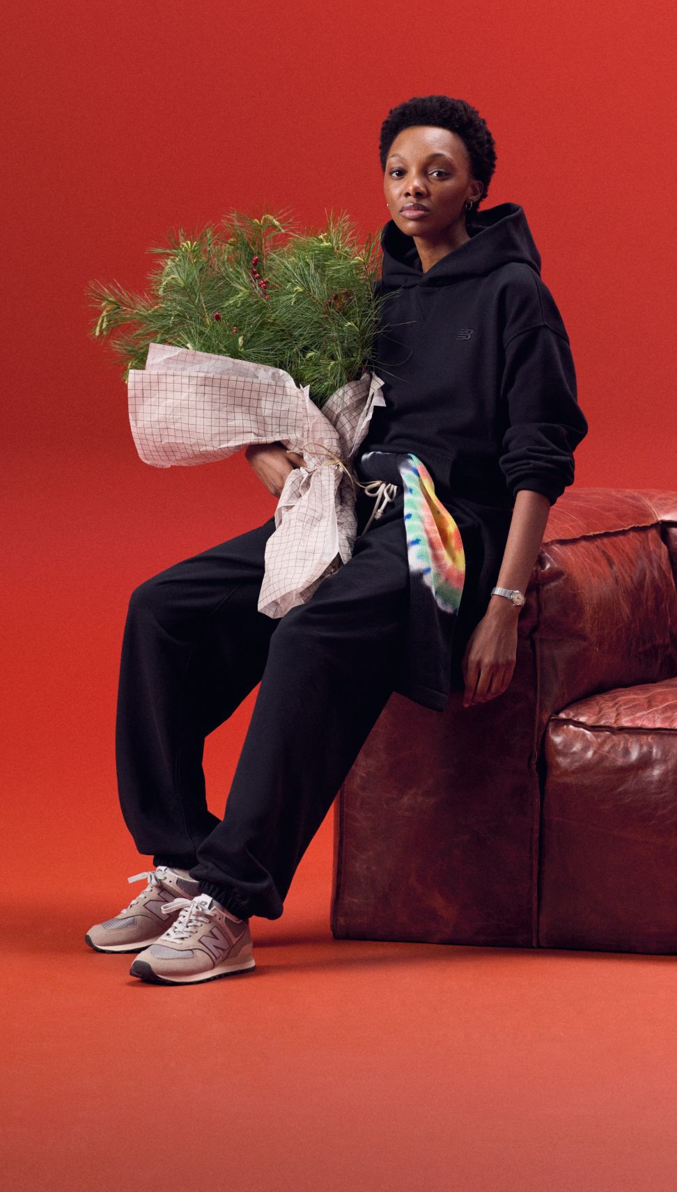 Young lady in a black matching set holding greens. 