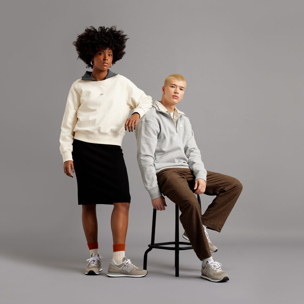 Man and woman posing together wearing grey 574s and NB apparel