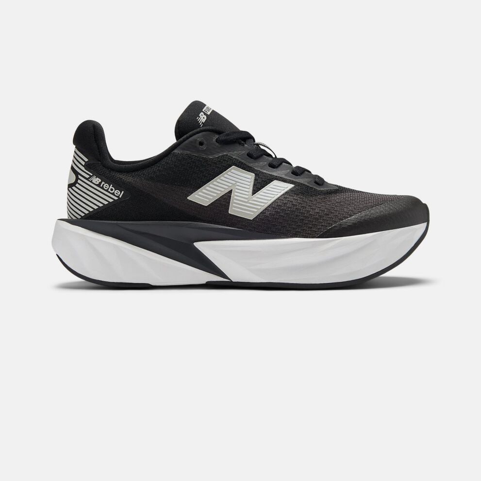 Side profile of a black New Balance running shoe on a white background, featuring a breathable mesh upper, reflective silver &ldquo;N&rdquo; logo, padded collar, and a thick sculpted white and black midsole. 