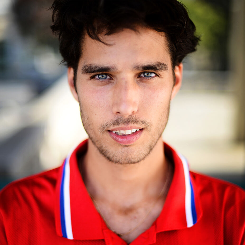 Close up of skateboarder Tom Knox wearing a red polo shirt