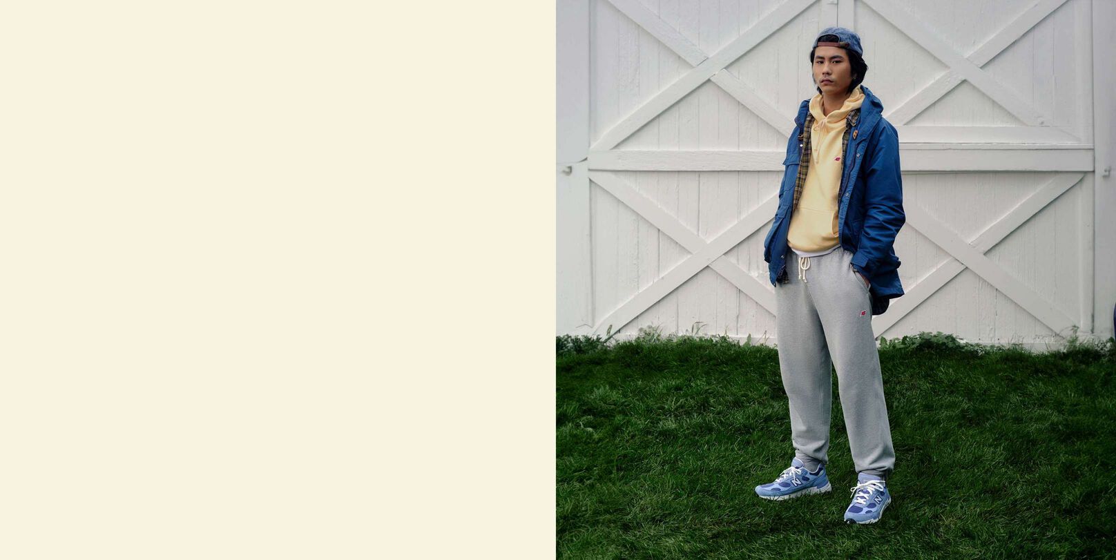 A man standing in front of set of white barn doors.