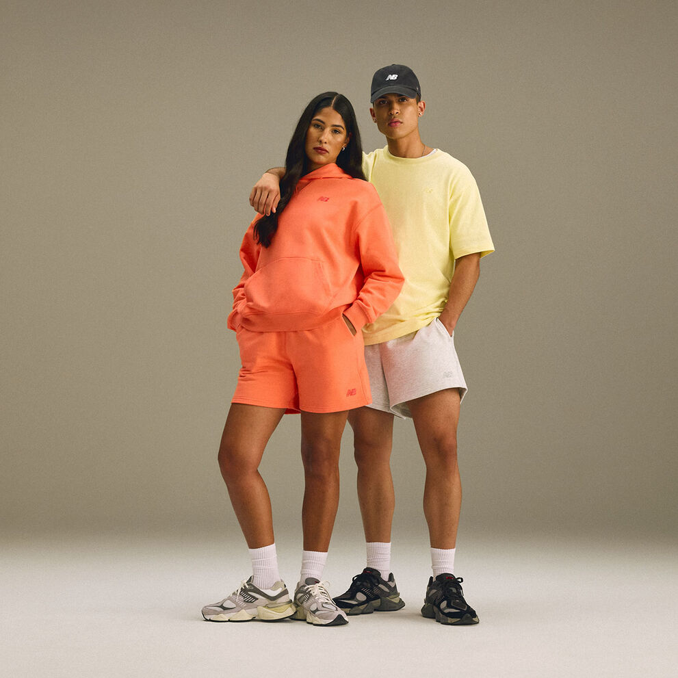 A man and woman standing together in a studio environment. 