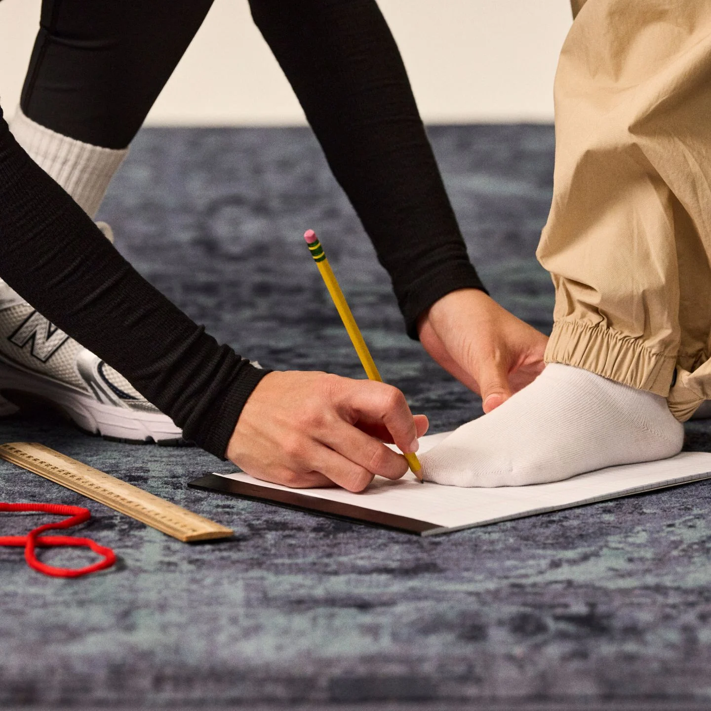 Someone measuring a child's foot.