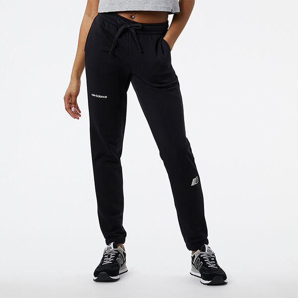Waist-down woman wearing black NB joggers and black/grey NB 574 sneakers