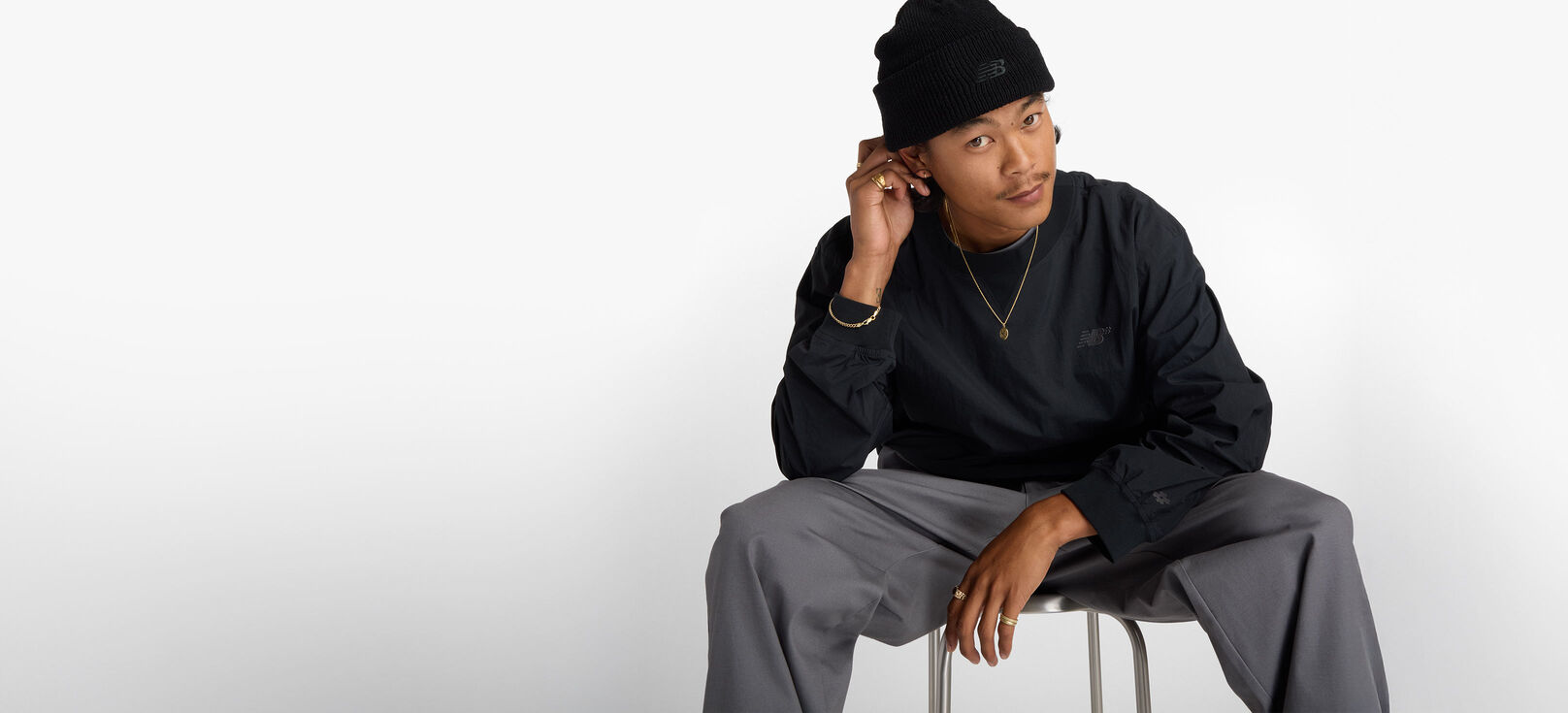 Skateboarder Patrick Praman sitting in a studio wearing Numeric apparel. 