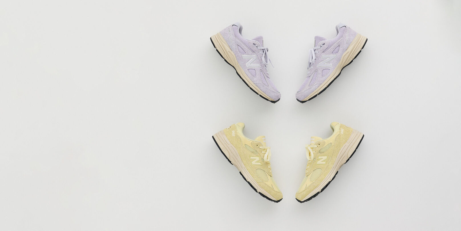 A pair of shoes laying in a grey studio backdrop.